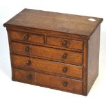 A 19th century miniature two-over-three chest of drawers, width 31cm.
