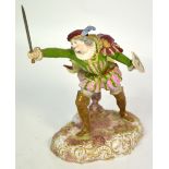 An early 20th century Continental figurine of a knight wielding a sword and shield on a grassy