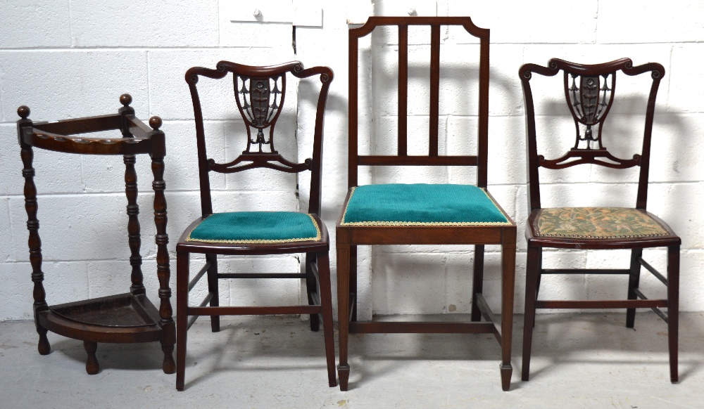 A pair of Edwardian mahogany bedroom chairs with carved central panel on tapering legs,