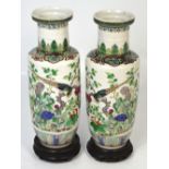 A very near pair of late 19th century Chinese famille verte vases decorated with birds amongst