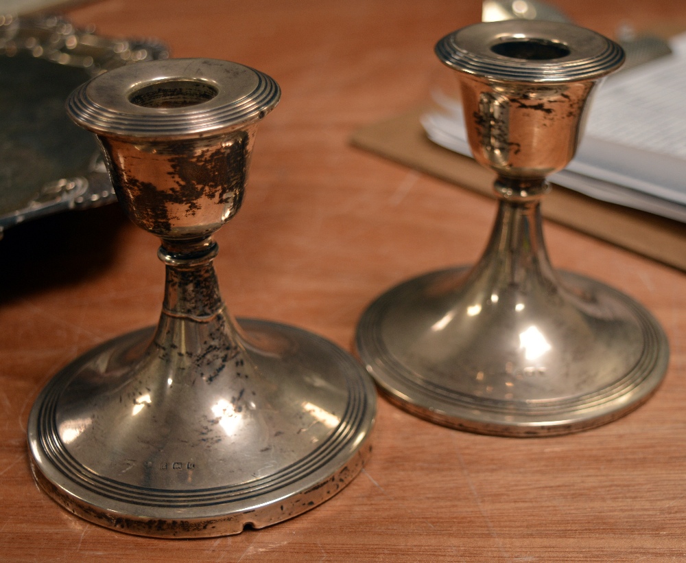 A pair of George V hallmarked silver loaded candlesticks, Birmingham 1919, height of both 10cm. - Image 2 of 2