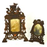 An early 20th century copper ornate picture frame decorated with figures in a boat and scrolls and