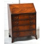 An early 20th century mahogany serpentine front bureau on splayed legs, 100 x 69cm.