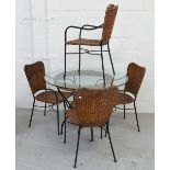 A circular glass and rattan garden table, width 107cm and a set of four chairs (5).