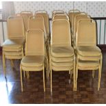 Fifty-seven gold painted and gold upholstered stacking chairs (57).