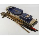 A group of nine early 20th century hickory shafted golf clubs contained in a vintage bag (10).