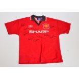 A red multi autographed Manchester United football shirt by Umbro, boys size "Large",