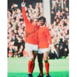 A large photograph of Denis Law celebrating a goal with George Best, autographed by Law, 40 x 30cm.