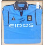 KEVIN KEEGAN; an Eidos sponsored Manchester City football shirt, signed by Keegan, 77 x 72cm,