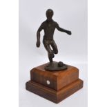 A c.1960s bronze statue of a footballer, on a wooden base.