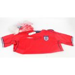 A red Wayne Rooney autographed England football shirt by Umbro, with original tags,