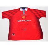 A red multi signed Manchester United football shirt by Umbro,