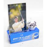 TIGER WOODS; a Dunlop golf ball autographed by Tiger Woods with black marker pen,