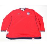 A red Steven Gerrard autographed England football shirt by Umbro, with original tag attached,