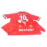 A red autographed Manchester United home shirt by Umbro,