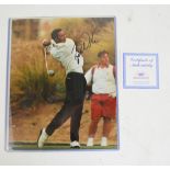 TIGER WOODS; a signed photograph of Tiger Woods in full swing, the autograph being an early example,