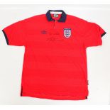 An autographed blue England football shirt, by Umbro,