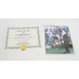 TIGER WOODS; a colour photograph signed by Tiger Woods in gold pen,