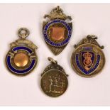 Four 9ct gold medallions relating to the Derbyshire Football Association including a shield shaped