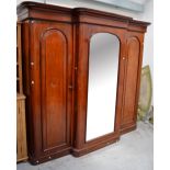 A Victorian mahogany break front mirror door triple wardrobe,