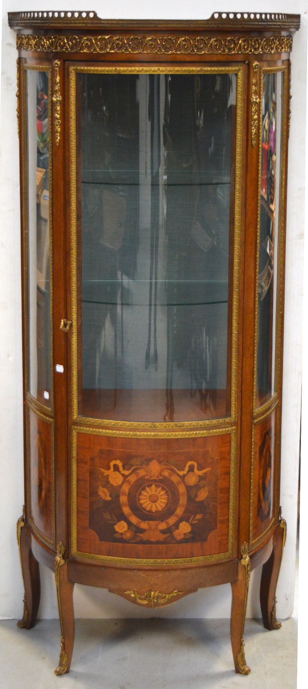 A c1900 French mahogany display cabinet with ribbon and swag inlay and gilt metal decoration