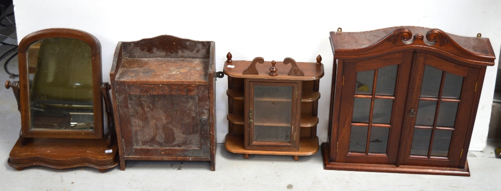 Two small glazed display cabinets, an oak cupboard with single door and a toilet mirror (4).