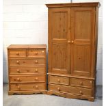 A contemporary pine two door wardrobe with three lower drawers,