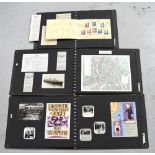 Three photograph albums containing photographs, postcards and newspaper cuttings,