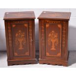 A pair of 20th century mahogany bedside cabinets with Art Nouveau floral ribbon and swag inlay on a