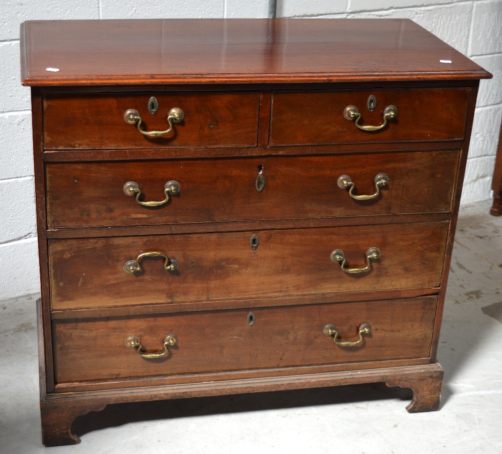 A 19th century mahogany two-over-three chest of drawers with brass handles and escutcheons on