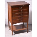 An Edwardian mahogany five drawer music cabinet, on tapering legs, width 52cm.