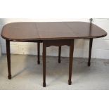 A reproduction mahogany dropleaf dining table on tapering legs and block feet,