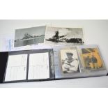 A black album containing approximately fifty postcards,