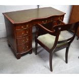 A nine drawer mahogany green leather inset desk on bracket feet,