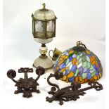 A Tiffany style light shade, a glass lantern style table lamp and a pair of wall sconces.