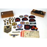 A quantity of military badges to include Naval badges,