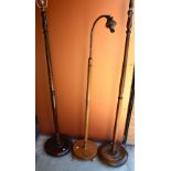 Three wooden standard lamps, the tallest approx 60cm high.