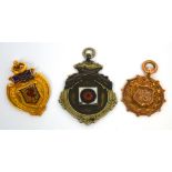 Three sporting medals to include a 9ct gold medal with enamel shield to the centre depicting a