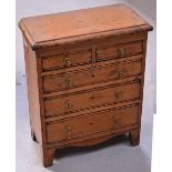 A miniature two over three apprentice chest of drawers, height 35cm.