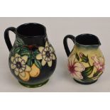 Two modern Moorcroft floral decorated tubelined jugs, one dated 1997,