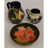 Two modern Moorcroft floral decorated tubelined jugs,