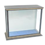 A stained wooden glazed model display cabinet with blue velvet lined base, 37 x 44 x 19cm.