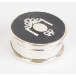 A George V hallmarked silver circular pill box with detachable tortoiseshell set pique decorated