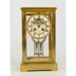 An early 20th century brass four glass eight day mantel clock,