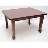 An Edwardian mahogany extending dining table with rectangular top with canted corners,