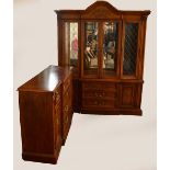 An American display cabinet, the rounded pediment with applied decoration,