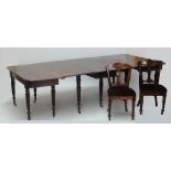 In the manner of GILLOWS; a large 19th century mahogany dining table with central dropleaf section,