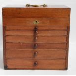 A small Victorian mahogany specimen cabinet with hinged lid and brass central handle,