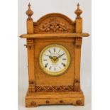 An early 20th century oak patent automatic alarm mantel clock with white enamel dial set with Roman
