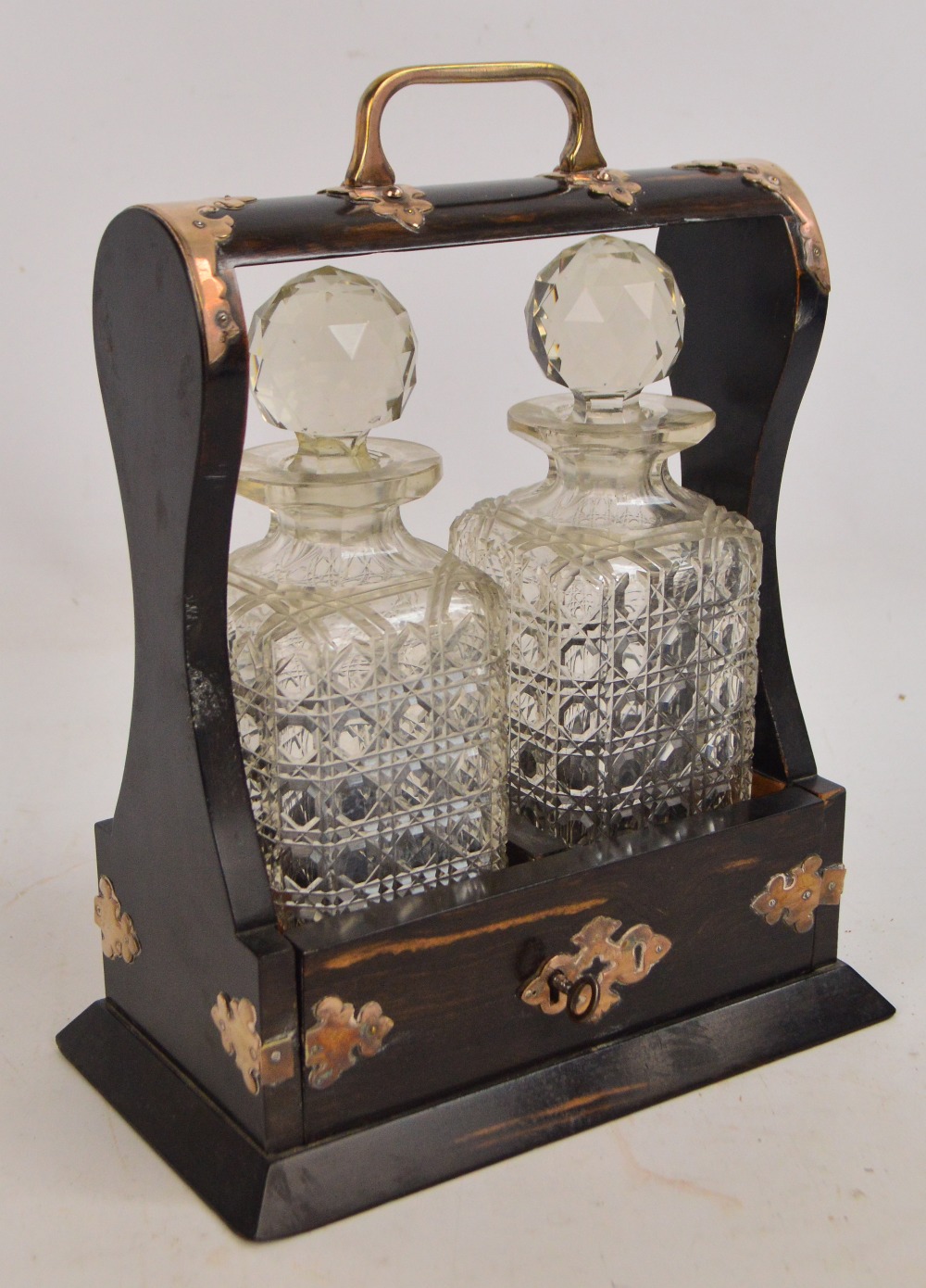 A Victorian coromandel electroplated mounted tantalus housing two clear hobnail cut glass square